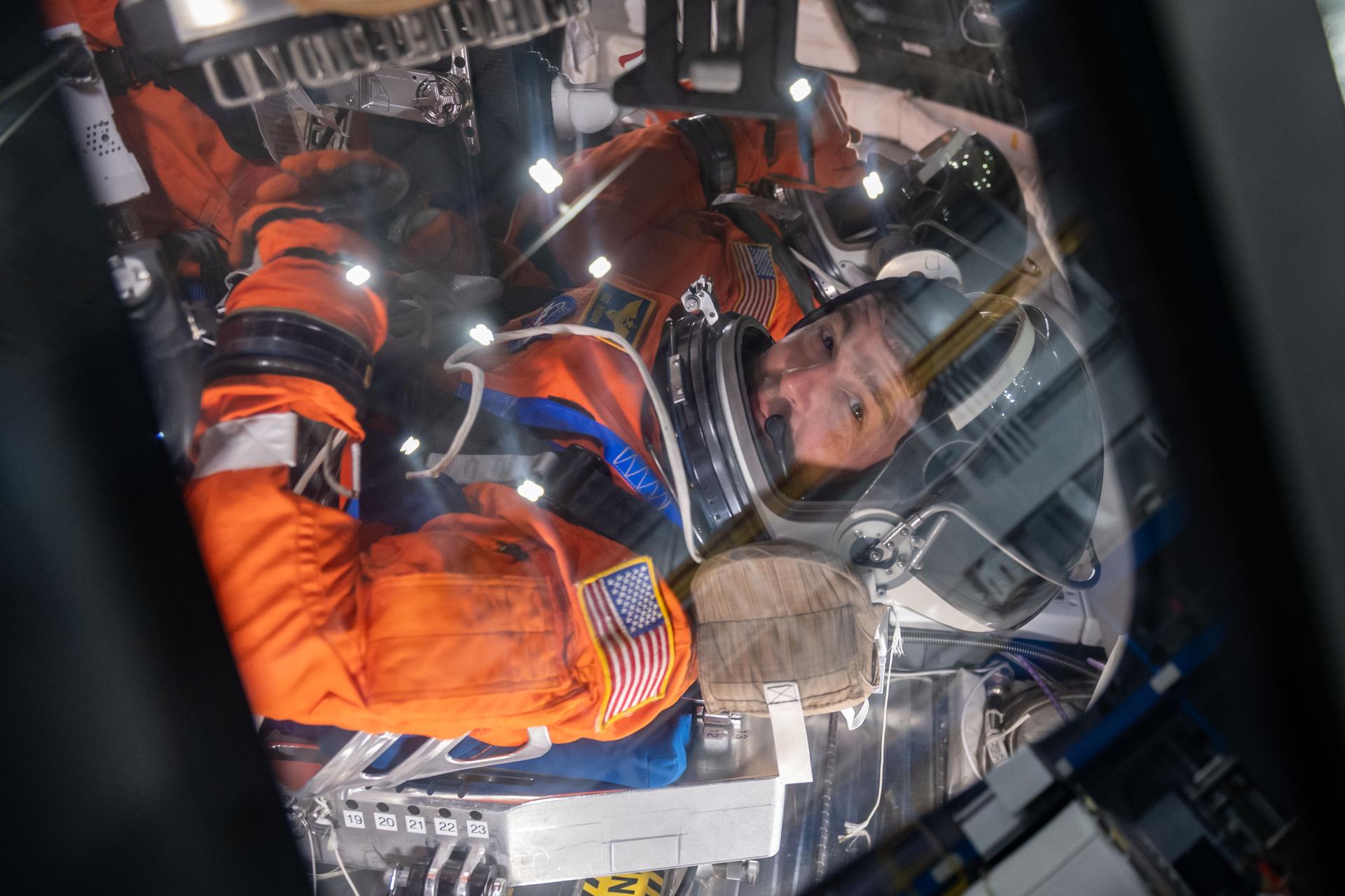 NASA astronauts and Artemis II crew members Reid Wiseman and Victor Glover inside of the Orion spacecraft mockup during Post Insertion and Deorbit Preparation training at the Space Vehicle Mockup Facility in Houston, Texas. The crew practiced getting the Orion spacecraft configured once in orbit, how to make it habitable, and suited up in their entry pressure suits to prepare for their return from the Moon.