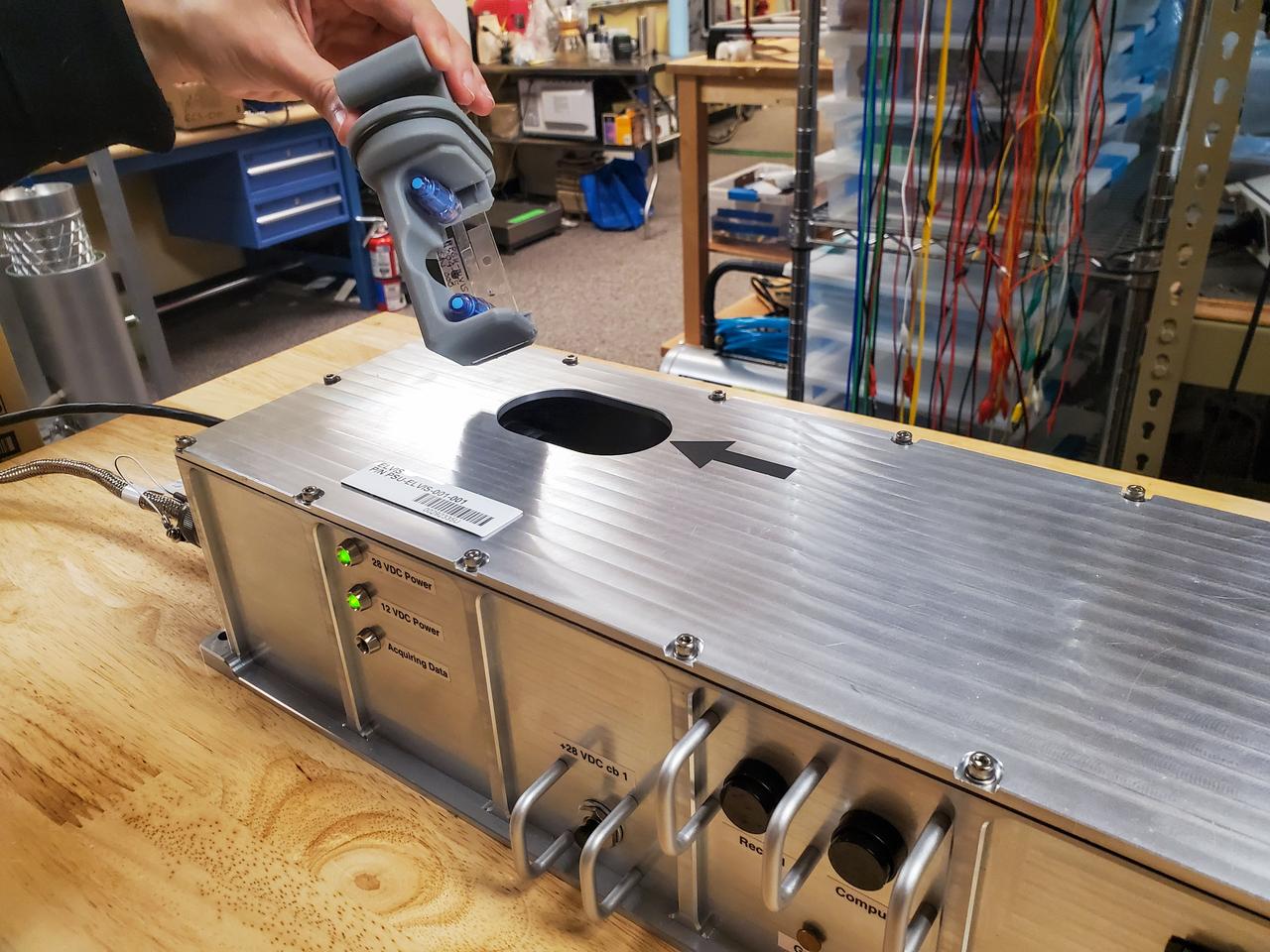 Closeup of the sample chamber being inserted into the ELVIS box.