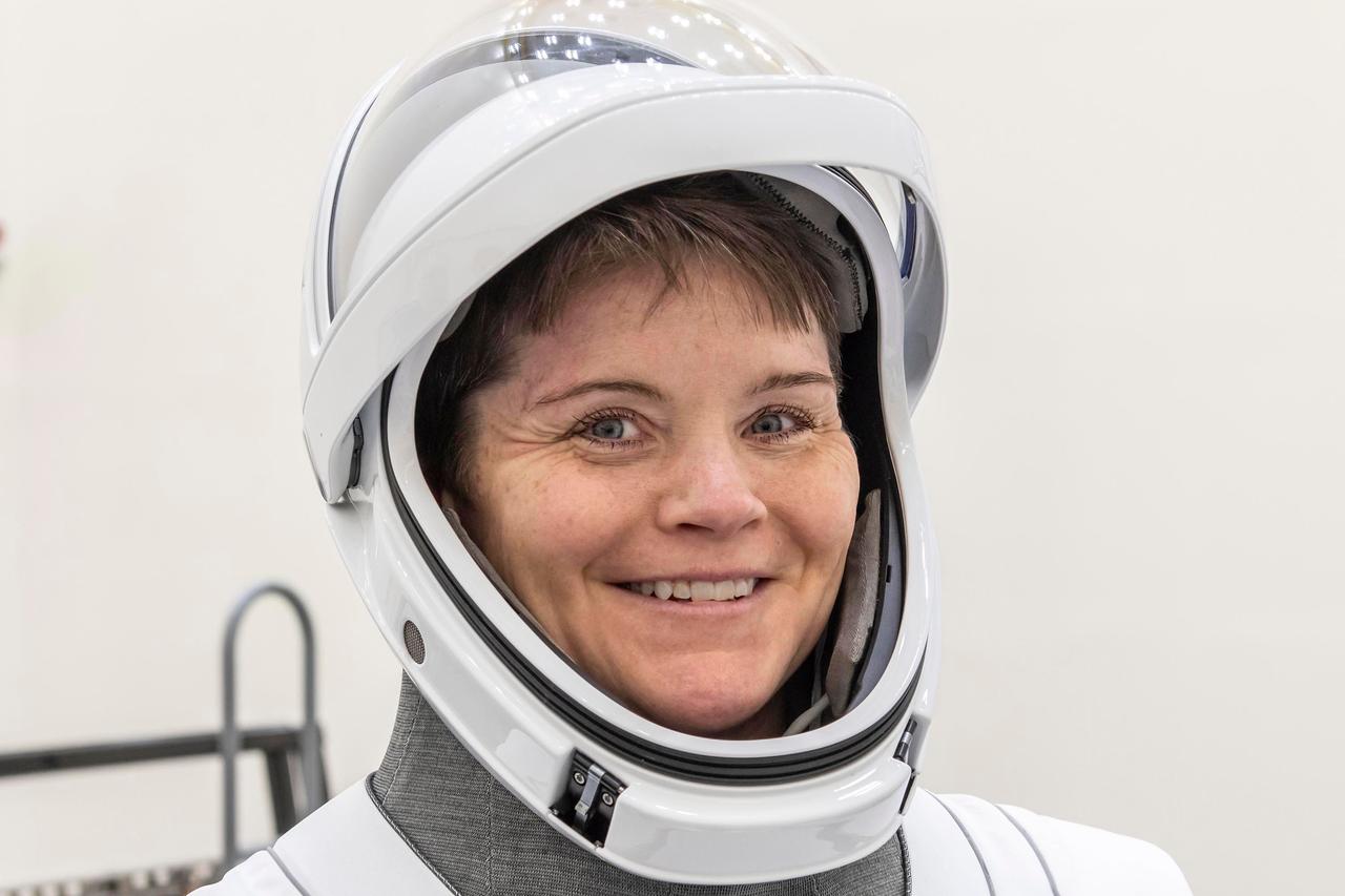 jsc2025e012271 - (February 17, 2025) --- NASA’s SpaceX Crew-10 Commander Anne McClain smiles in her flight suit at NASA's Kennedy Space Center in Florida.