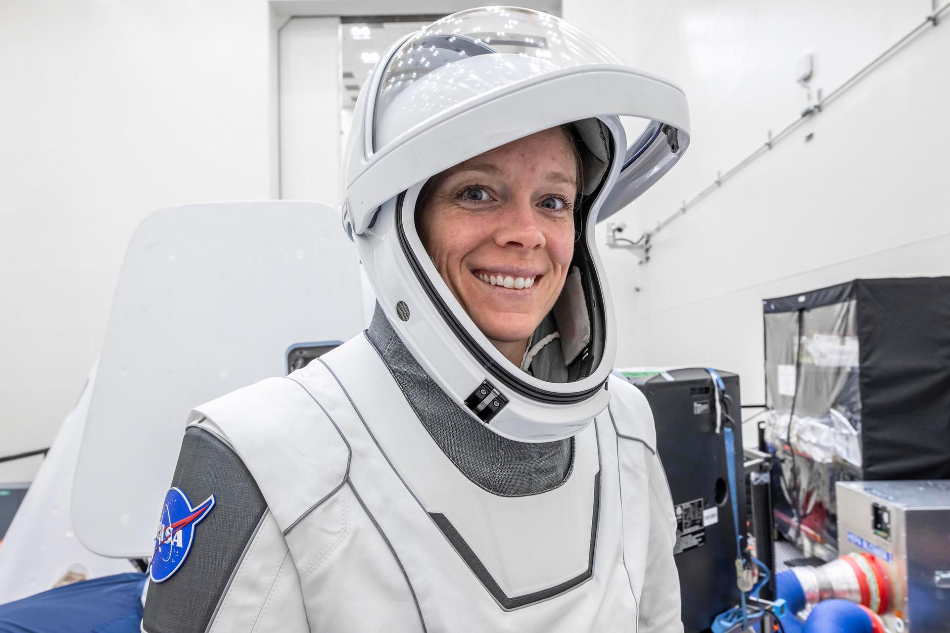 NASA’s SpaceX Crew-10 Pilot Nichole Ayers smiles in her flight suit at NASA's Kennedy Space Center in Florida.