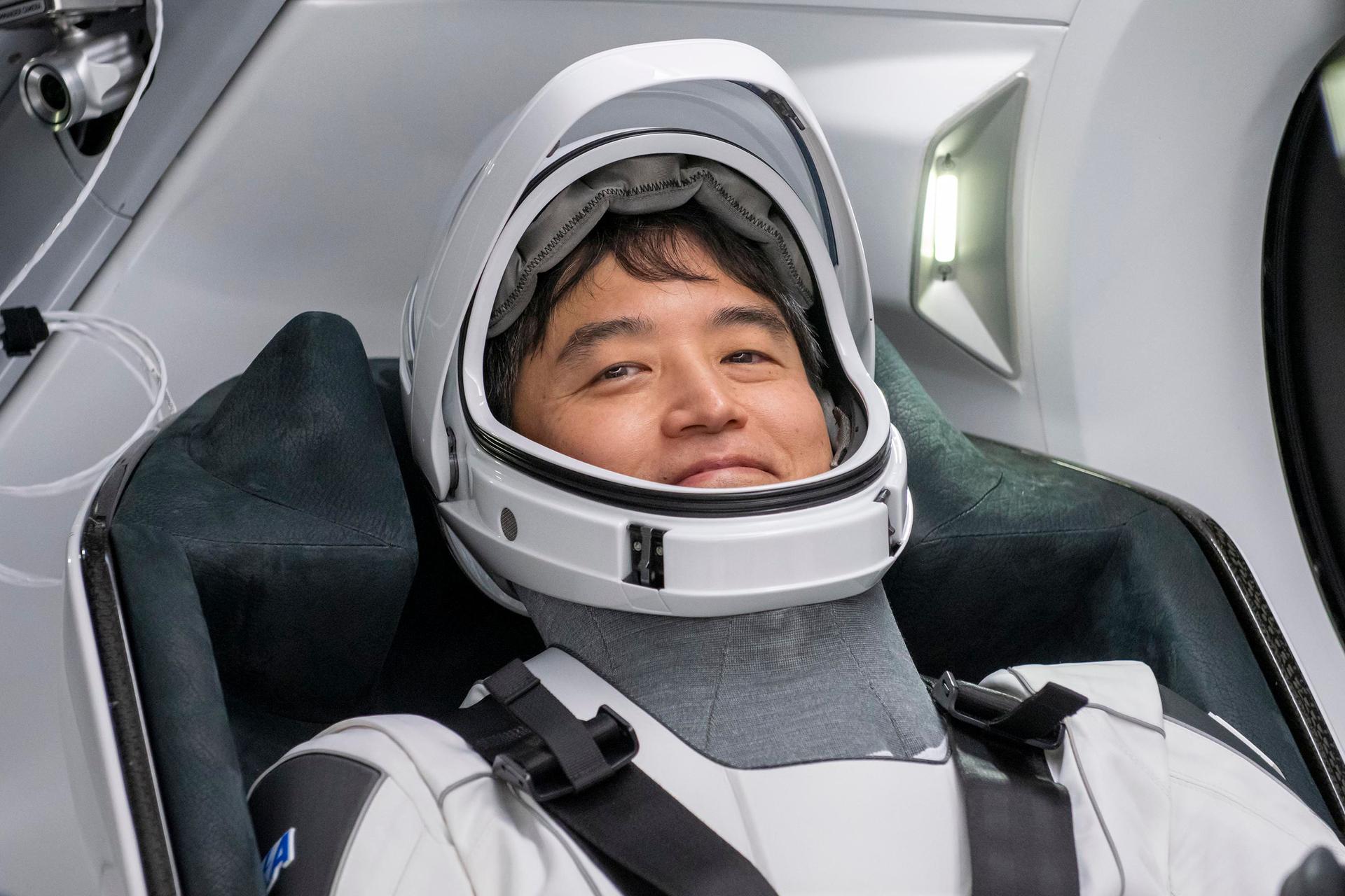 SpaceX Crew-10 Mission Specialist Takuya Onishi of JAXA (Japan Aerospace Exploration Agency) smiles in his flight suit at NASA's Kennedy Space Center in Florida.