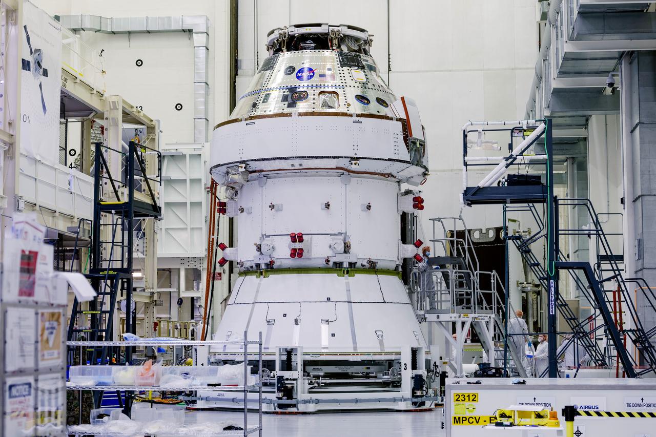 Date: 2/27/2025 Photographer: NASA/Rad Sinyak Caption: Technicians begin working on the installation of the four solar array wings for NASA’s Artemis II Orion spacecraft inside the Operations and Checkout Building at NASA’s Kennedy Space Center on Feb. 27, 2025. Artemis II is Orion’s first crewed flight test around the Moon under the agency’s Artemis campaign.  