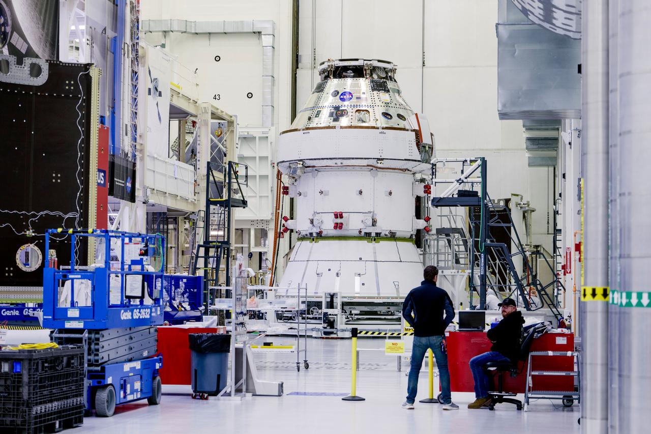 Date: 2/27/2025 Photographer: NASA/Rad Sinyak Caption: Technicians begin working on the installation of the four solar array wings for NASA’s Artemis II Orion spacecraft inside the Operations and Checkout Building at NASA’s Kennedy Space Center on Feb. 27, 2025. Artemis II is Orion’s first crewed flight test around the Moon under the agency’s Artemis campaign.  