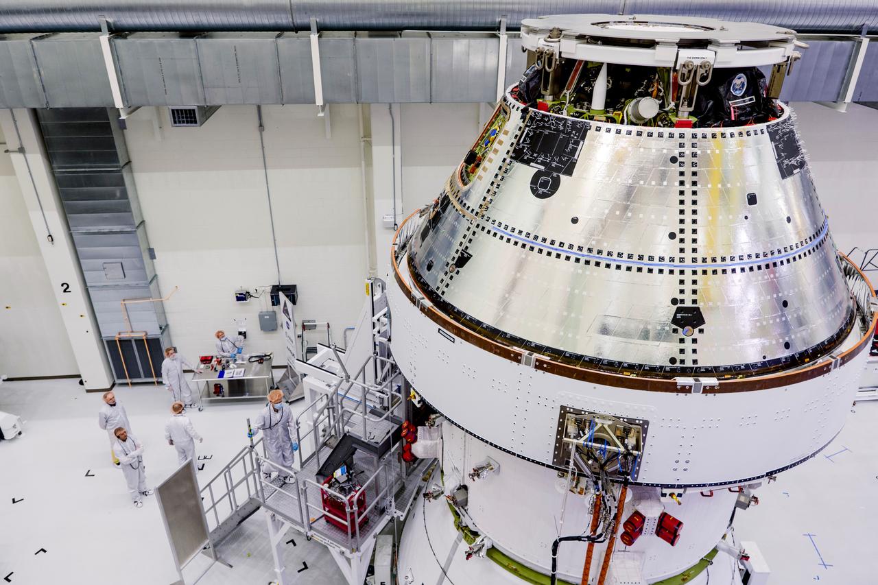 Date: 2/27/2025 Photographer: NASA/Rad Sinyak Caption: Technicians begin working on the installation of the four solar array wings for NASA’s Artemis II Orion spacecraft inside the Operations and Checkout Building at NASA’s Kennedy Space Center on Feb. 27, 2025. Artemis II is Orion’s first crewed flight test around the Moon under the agency’s Artemis campaign.  