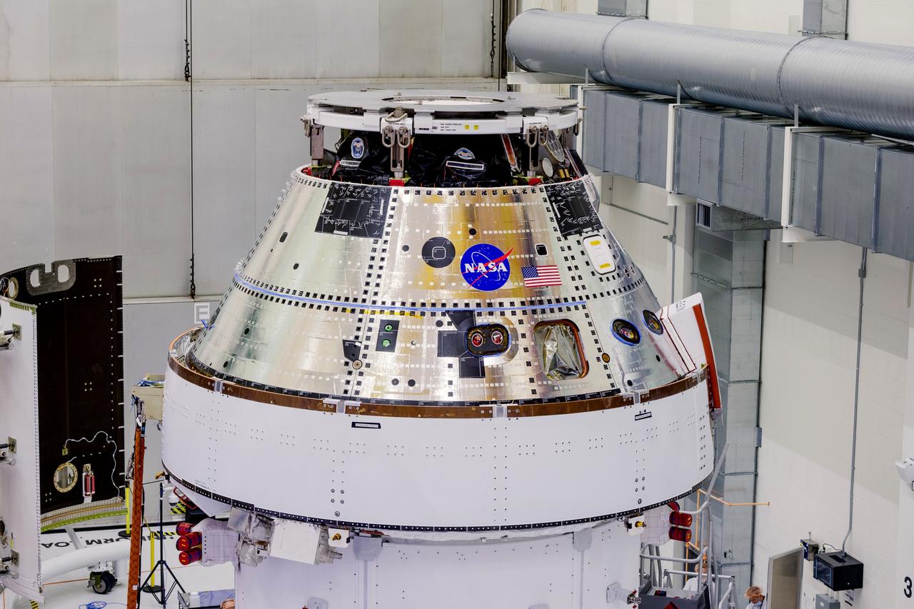 Date: 2/27/2025 Photographer: NASA/Rad Sinyak Caption: Technicians begin working on the installation of the four solar array wings for NASA’s Artemis II Orion spacecraft inside the Operations and Checkout Building at NASA’s Kennedy Space Center on Feb. 27, 2025. Artemis II is Orion’s first crewed flight test around the Moon under the agency’s Artemis campaign.