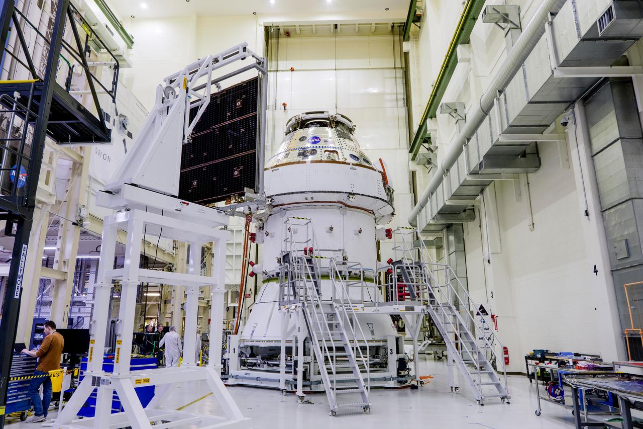 Date: 2/27/2025 Photographer: NASA/Rad Sinyak Caption: Technicians begin working on the installation of the four solar array wings for NASA’s Artemis II Orion spacecraft inside the Operations and Checkout Building at NASA’s Kennedy Space Center on Feb. 27, 2025. Artemis II is Orion’s first crewed flight test around the Moon under the agency’s Artemis campaign.  