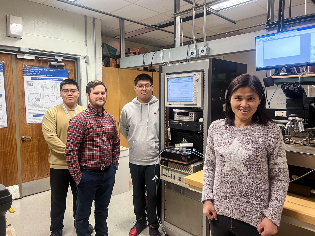 jsc2025e015682 (3/6/2025) --- From left to right: students, Tuofu Zhama, Alex Katorkas, Haochen Zhao, and Principal Investigator Yuping Zeng stand beside the equipment for GaN devices electrical property measurement before the packaging. The High Performance Radiation Hardened GaN High Electron Mobility Transistors for Space Applications (Radiation Harden GaN) investigation studies how radiation affects a type of transistor used in the semiconductor industry. Researchers measure the performance of the devices before, during, and after flight to determine whether performance degrades. This could help determine how well the transistors can tolerate radiation in space. Image courtesy of Department of Electrical and Computer Engineering, University of Delaware.