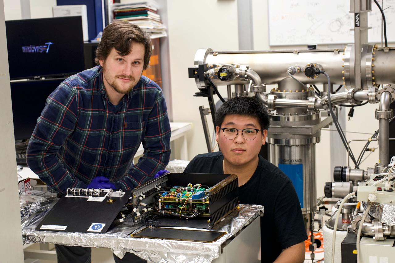 jsc2025e015687 (3/6/2025) --- Alex Katorkas (left) and Haochen Zhao (right) work in front of a prototype as part of the High Performance Radiation Hardened GaN High Electron Mobility Transistors for Space Applications (Radiation Harden GaN) investigation which studies how radiation affects a type of transistor used in the semiconductor industry. Researchers measure the performance of the devices before, during, and after flight to determine whether performance degrades. This could help determine how well the transistors can tolerate radiation in space.  Image courtesy of Department of Electrical and Computer Engineering, University of Delaware.
