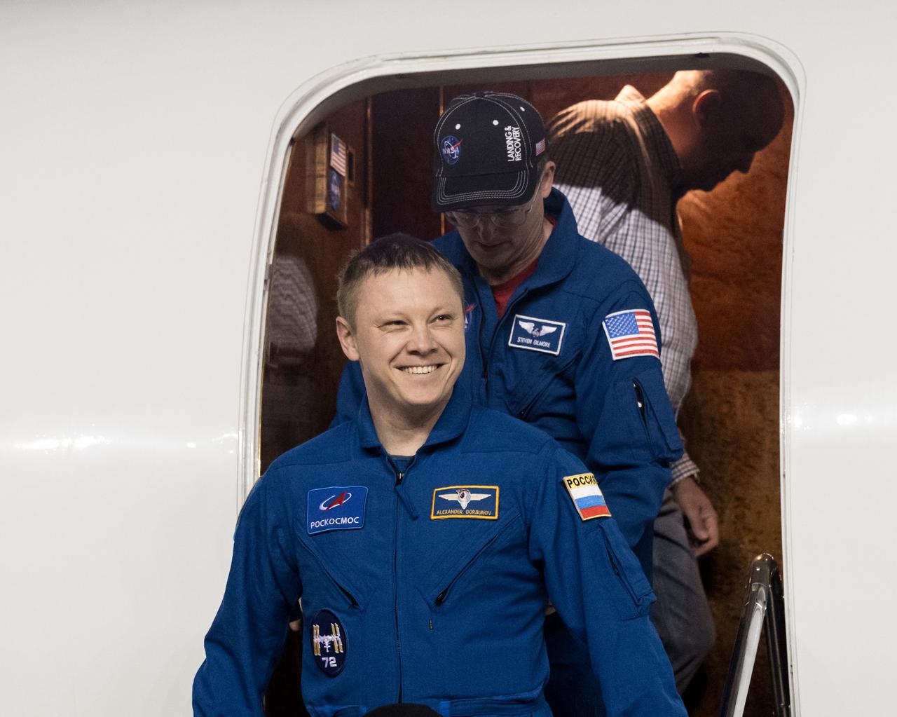 jsc2025e032537 (March 18, 2025) --- Roscosmos cosmonaut Aleksandr Gorbunov smiles as he returns to Johnson Space Center's Ellington Field in Houston after completing a long-duration science mission aboard the International Space Station. After undocking from the orbiting laboratory, NASA’s SpaceX Crew-9 splashed down at 5:57 p.m. EDT on Tuesday, March 18, in the Gulf of America near Tallahassee, Florida.