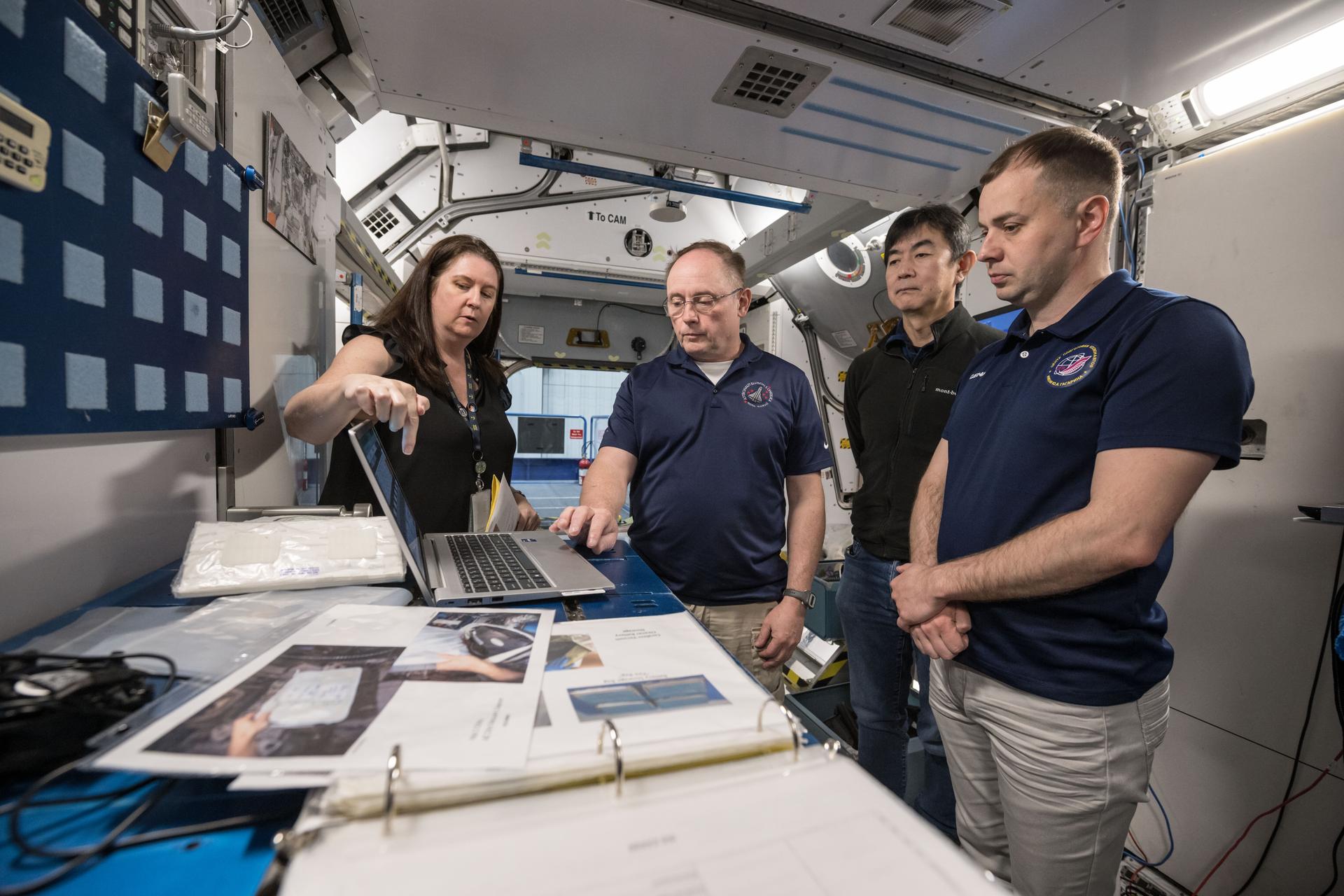 From left to right, NASA astronaut Mike Fincke, JAXA astronaut Kimiya Yui, and Roscosmos Cosmonaut Oleg Platonov conduct training scenarios with their instructor (far left) at NASA’s Johnson Space Center in Houston, Texas, for their upcoming mission to the International Space Station