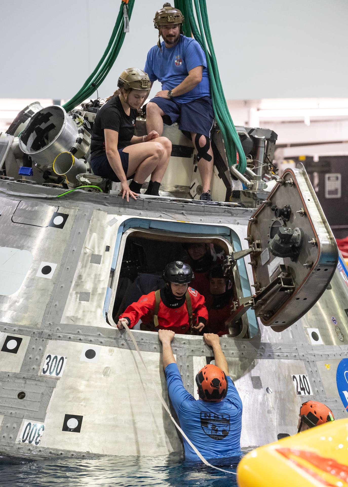 The four crew members of NASA’s SpaceX Crew-11 mission to the International Space Station participate in a water survival demonstration at the Neutral Buoyancy Lab.