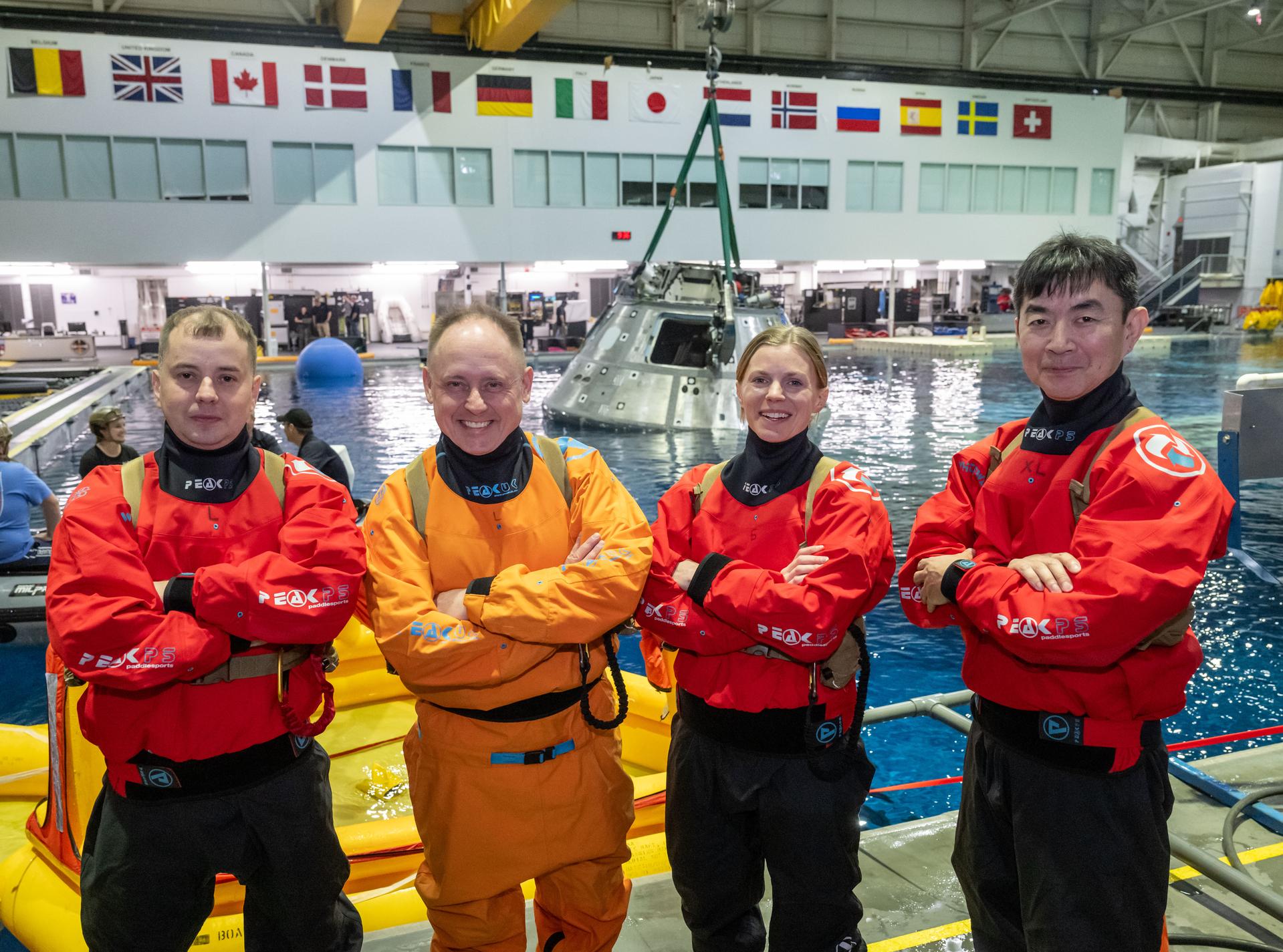 The four crew members of NASA’s SpaceX Crew-11 mission to the International Space Station pose for a group photo after participating in a water survival demonstration at the Neutral Buoyancy Lab.