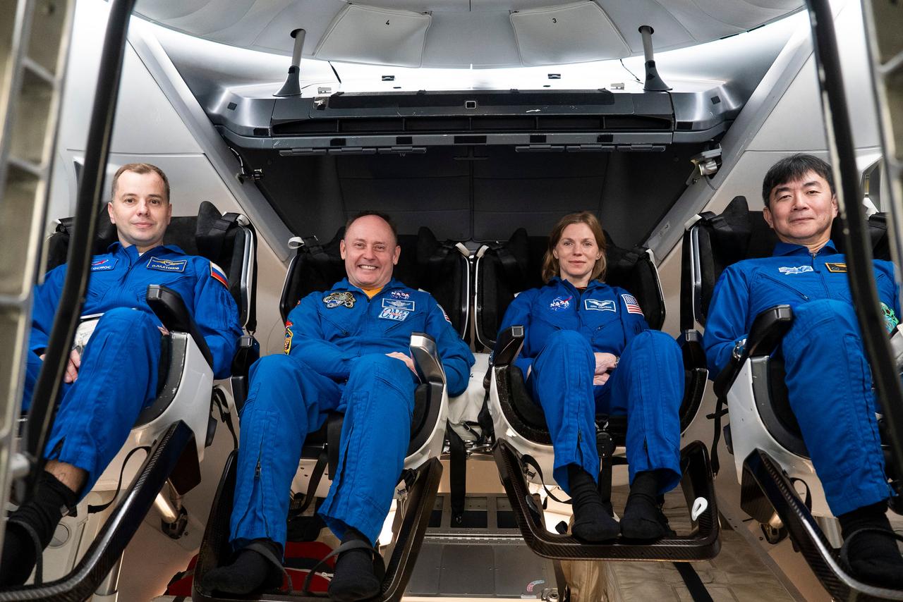 jsc2025e041083 (April 9, 2025) --- The four crew members of NASA's SpaceX Crew-11 mission to the International Space Station train inside a Dragon training crew spacecraft at SpaceX in Hawthorne, California. From left to right: Roscosmos cosmonaut Oleg Platonov, NASA astronauts Mike Fincke and Zena Cardman, and JAXA astronaut Kimiya Yui.