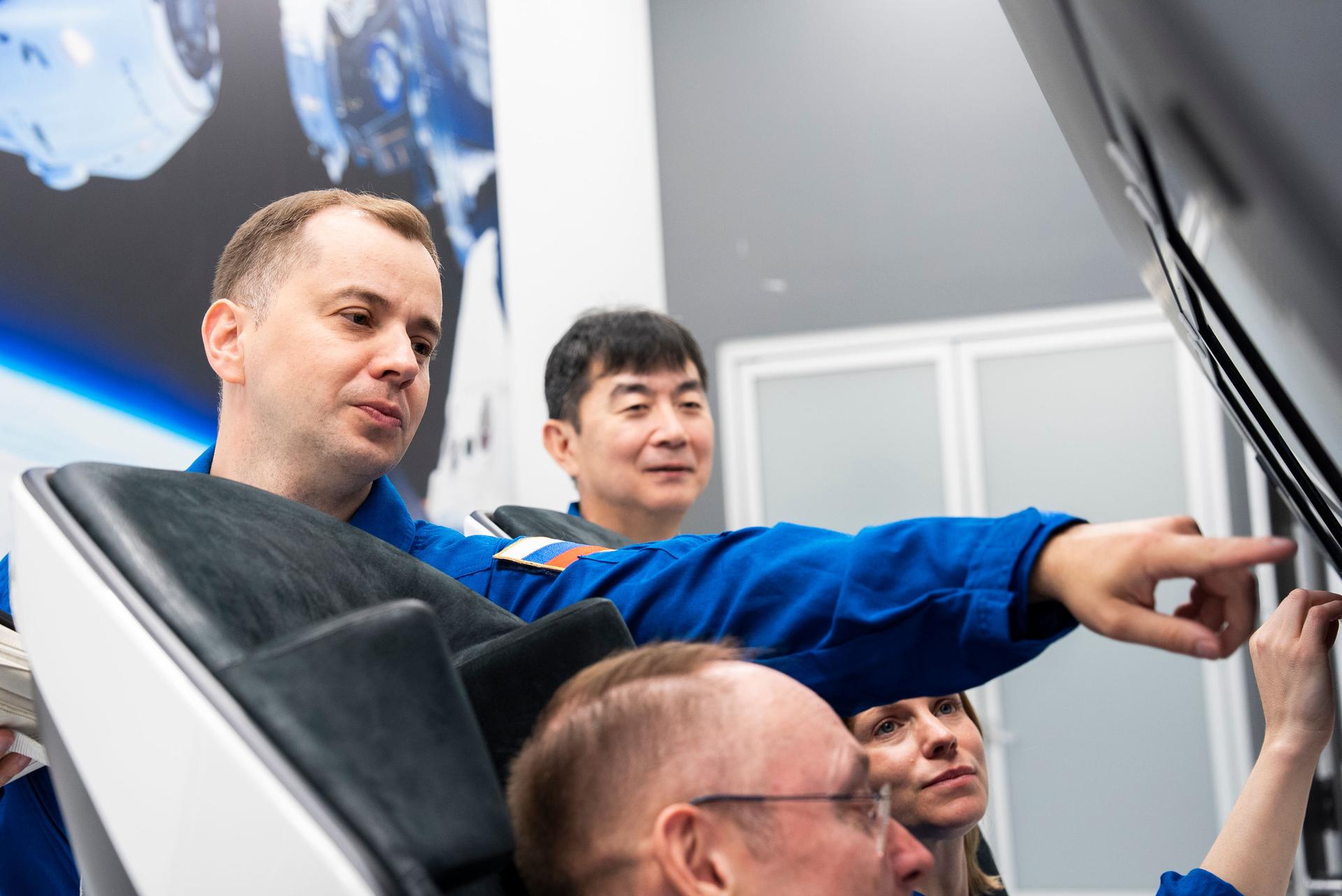The four crew members of NASA's SpaceX Crew-11 mission to the International Space Station train inside a Dragon training crew spacecraft at SpaceX in Hawthorne, California.
