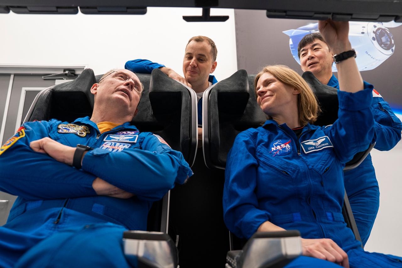jsc2025e041091 (April 9, 2025) --- The four crew members of NASA's SpaceX Crew-11 mission to the International Space Station train inside a Dragon training crew spacecraft at SpaceX in Hawthorne, California. From left to right: NASA astronaut Mike Fincke, Roscosmos cosmonaut Oleg Platonov, NASA astronaut Zena Cardman, and JAXA astronaut Kimiya Yui.