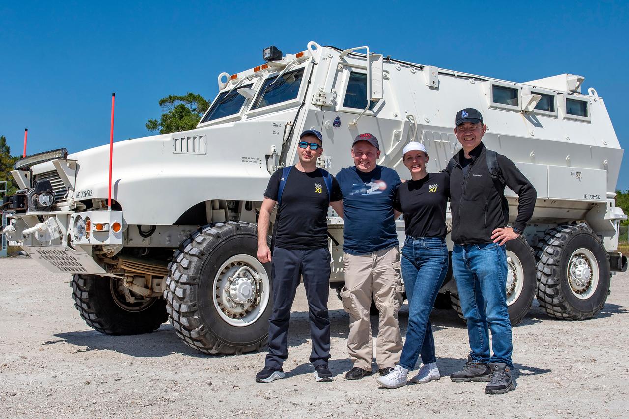 jsc2025e041098 (April 11, 2025) --- NASA’s SpaceX Crew-11 crew pose for a photo by an emergency egress vehicle at NASA’s Kennedy Space Center in Florida. Astronauts would use the emergency egress vehicle to quickly leave the launch area in the unlikely event of an emergency. From left to right: Roscosmos cosmonaut Oleg Platonov, NASA astronauts Mike Fincke and Zena Cardman, and JAXA astronaut Kimiya Yui.