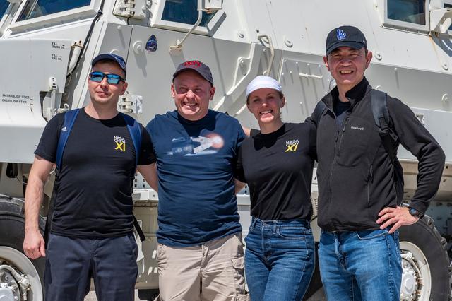 NASA image: NASA's SpaceX Crew-11 members pose for a portrait by an emergency egress vehicle