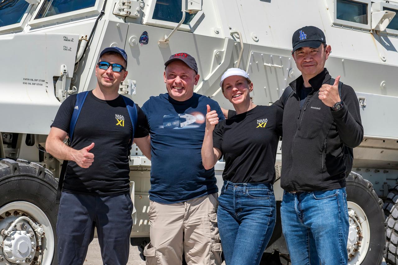 jsc2025e041100 (April 11, 2025) --- NASA’s SpaceX Crew-11 crew pose for a photo by an emergency egress vehicle at NASA’s Kennedy Space Center in Florida. Astronauts would use the emergency egress vehicle to quickly leave the launch area in the unlikely event of an emergency. From left to right: Roscosmos cosmonaut Oleg Platonov, NASA astronauts Mike Fincke and Zena Cardman, and JAXA astronaut Kimiya Yui.