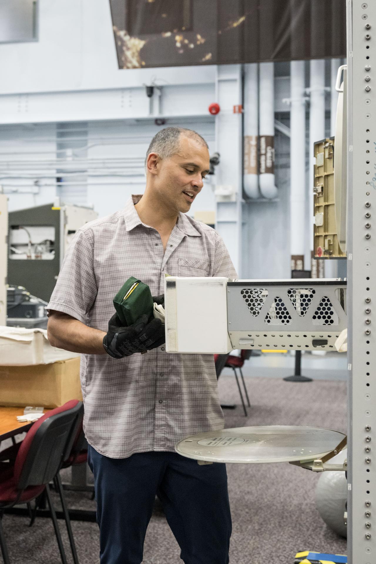 NASA astronaut and Expedition 75 flight engineer Anil Menon familiarizes himself with science harwdare at Johnson Space Center's Space Vehicle Mockup Facility in Houston, Texas, ahead of his upcoming mission to the International Space Station.