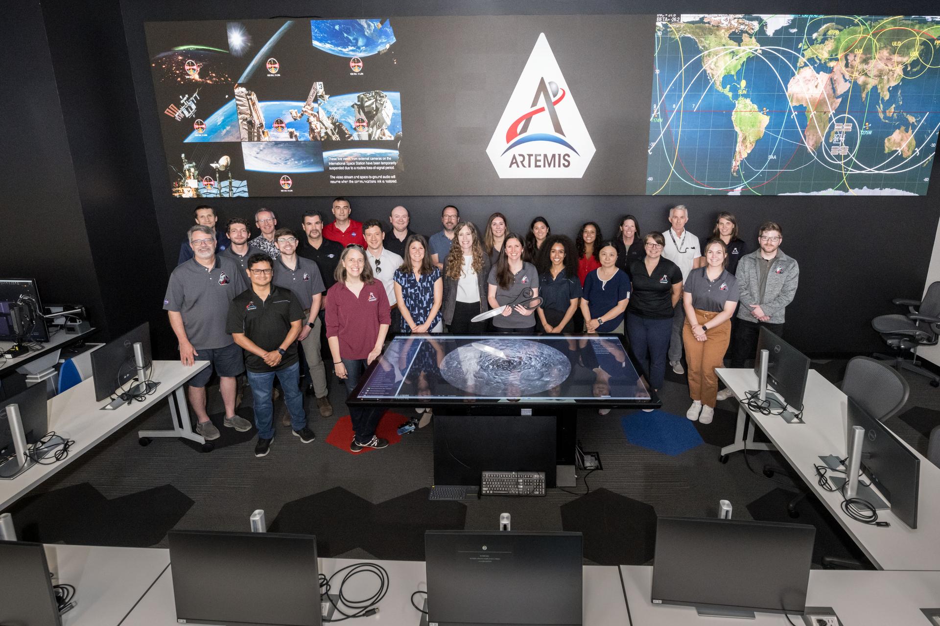 jsc2025e057255 --- NASA’s Artemis III lunar science team is pictured in the Science Evaluation Room (SER) at the agency’s Johnson Space Center in Houston. Located in the Christopher C. Kraft Jr. Mission Control Center, the SER supports the mission’s main flight control room for lunar science and planetary observations. Built specifically for Artemis missions with these science priorities in mind, the SER is equipped to support rapid data interpretation, collaborative analysis, real-time decision making, and seamless coordination between the science and operations teams.