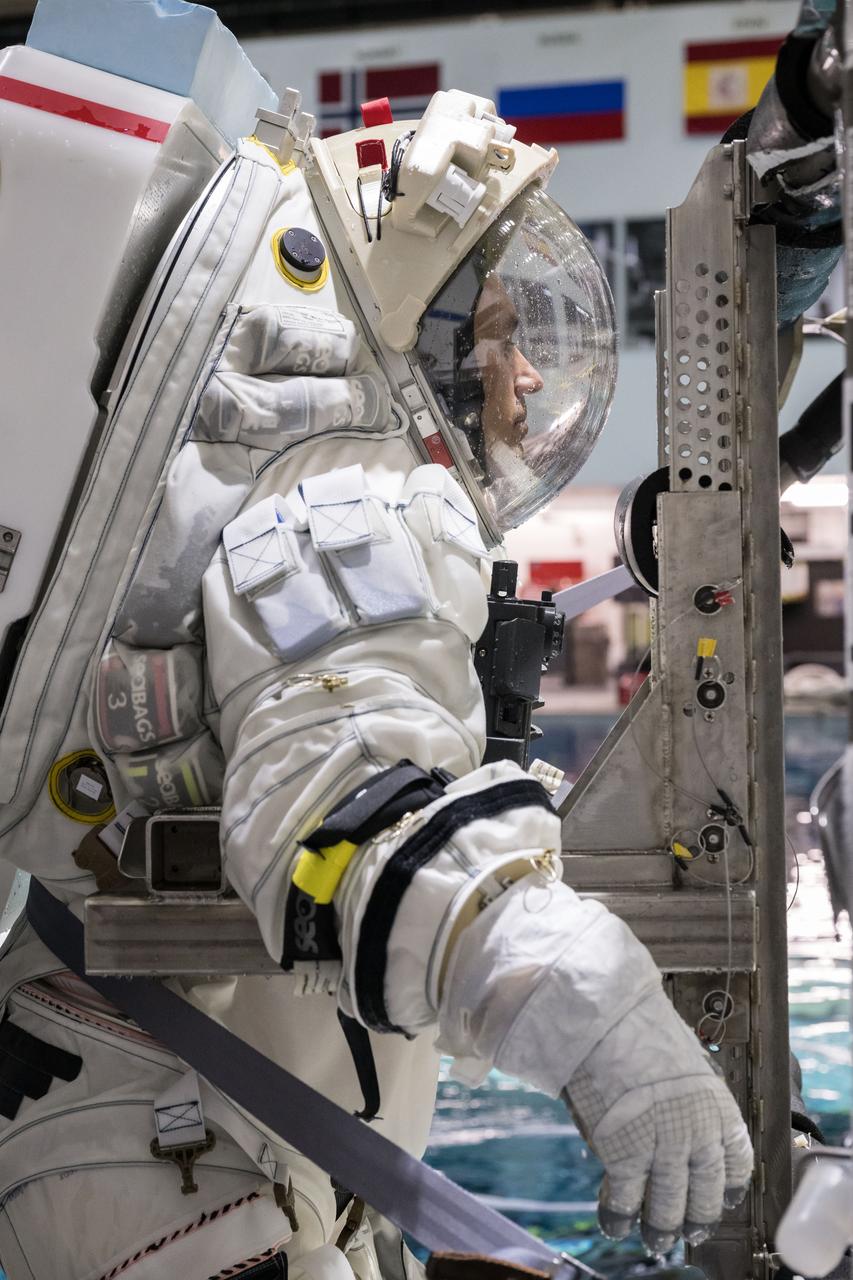 NASA spacesuit engineer Richard Rhodes suits up in Axiom Space's lunar spacesuit before going under water for testing at NASA's Neutral Buoyancy Laboratory. Image Credit: NASA/Robert Markowitz