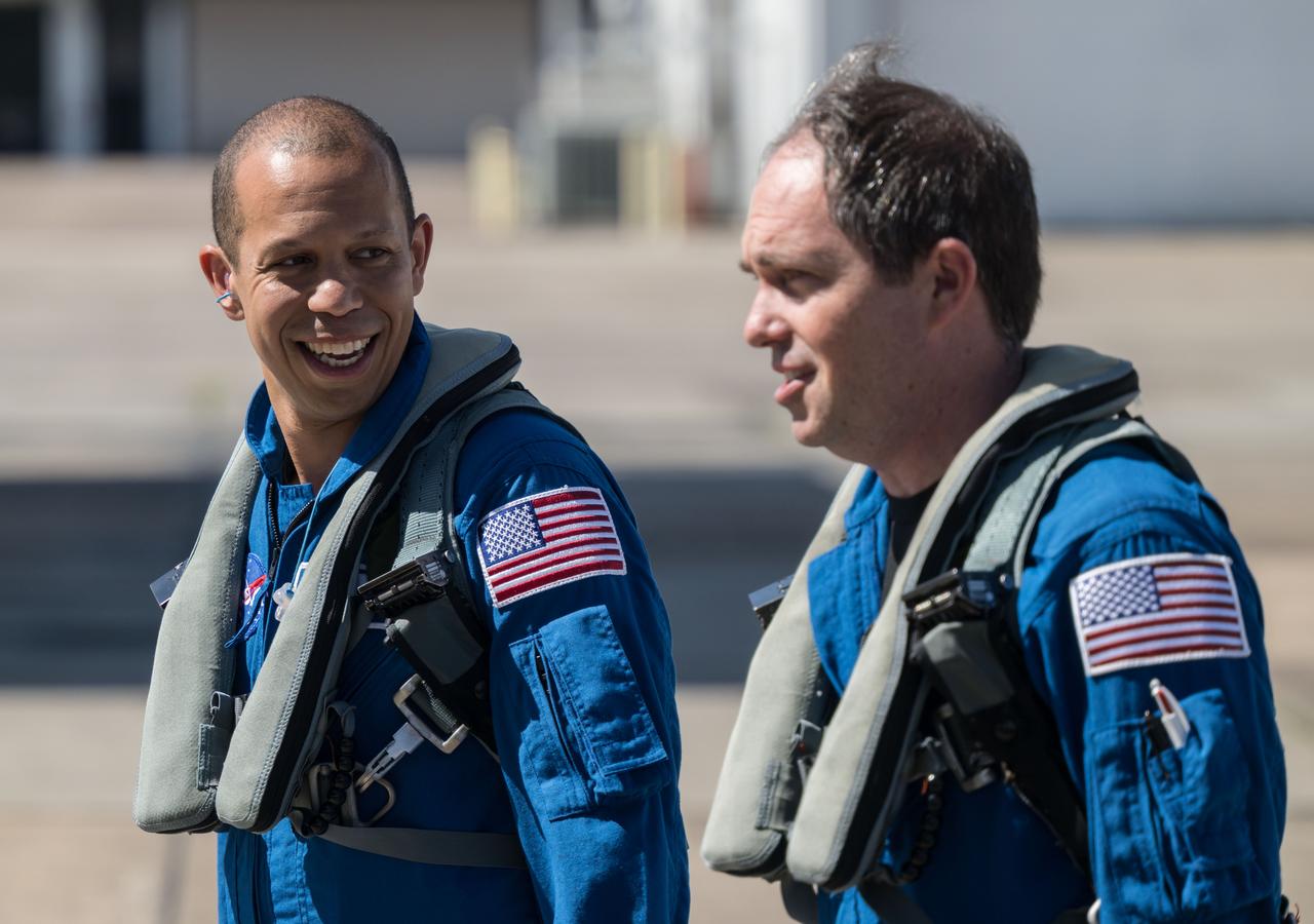 jsc2025e060539 (June 24, 2025) --- NASA astronaut Chris Williams (left) speaks with pilot John Gustine ahead of their flight on a T-38 jet out of Ellington Field in Houston, Texas. 