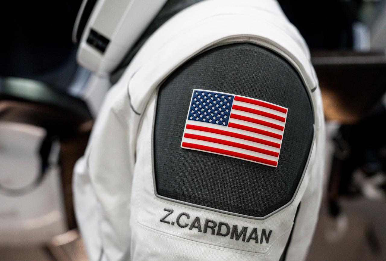 jsc2025e064526 (June 23, 2024) --- NASA’s SpaceX Crew-11 commander and NASA astronaut Zena Cardman participates in a training session at SpaceX facilities in Hawthorne, California. Her name, “Z. Cardman” is prominently shown with the American flag. Credit: SpaceX