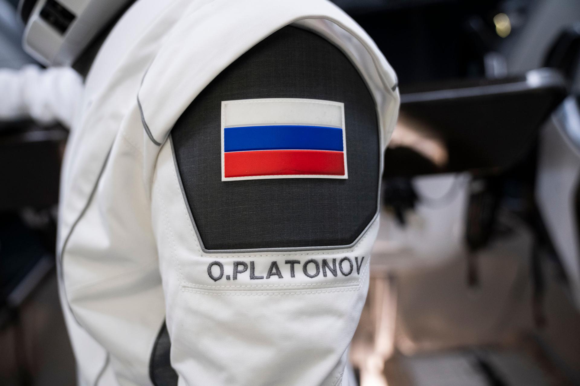  NASA’s SpaceX Crew-11 mission specialist and Roscosmos cosmonaut Oleg Platonov participates in a training session at SpaceX facilities in Hawthorne, California. His name, “O. Platonov” is prominently shown with the Russian flag.