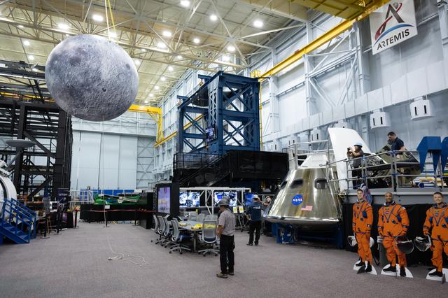 jsc2025e064769 --- An inflatable Moon is hoisted above the Orion mockup at NASA