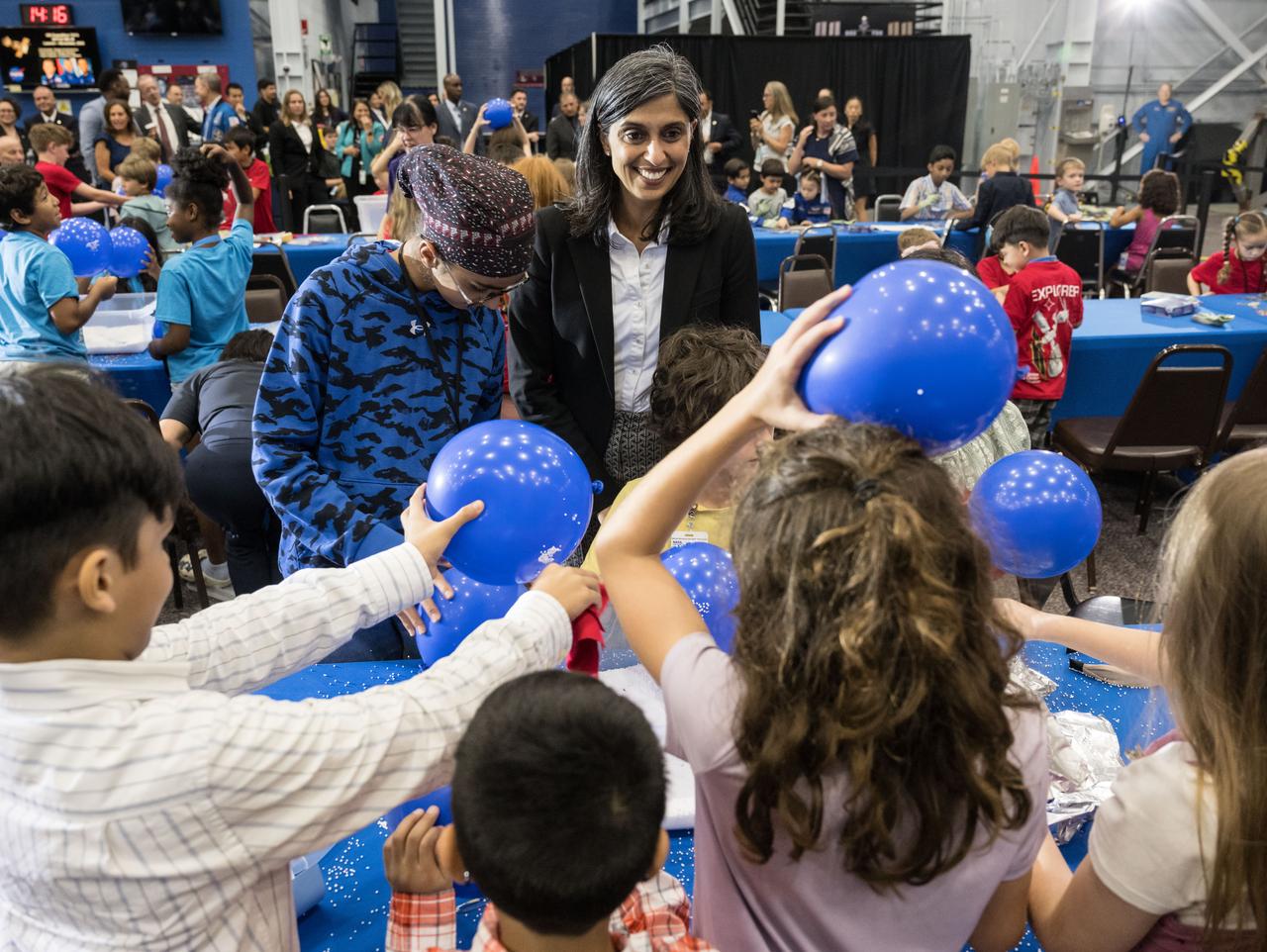 jsc2025e067250 (August 4, 2025) --- Second Lady Usha Vance interacts with a group of children as they were participating in group activities as part of the Summer Reading Challenge event at NASA’s Johnson Space Center. Photo Credit: NASA/James Blair Photo Credit: NASA/James Blair