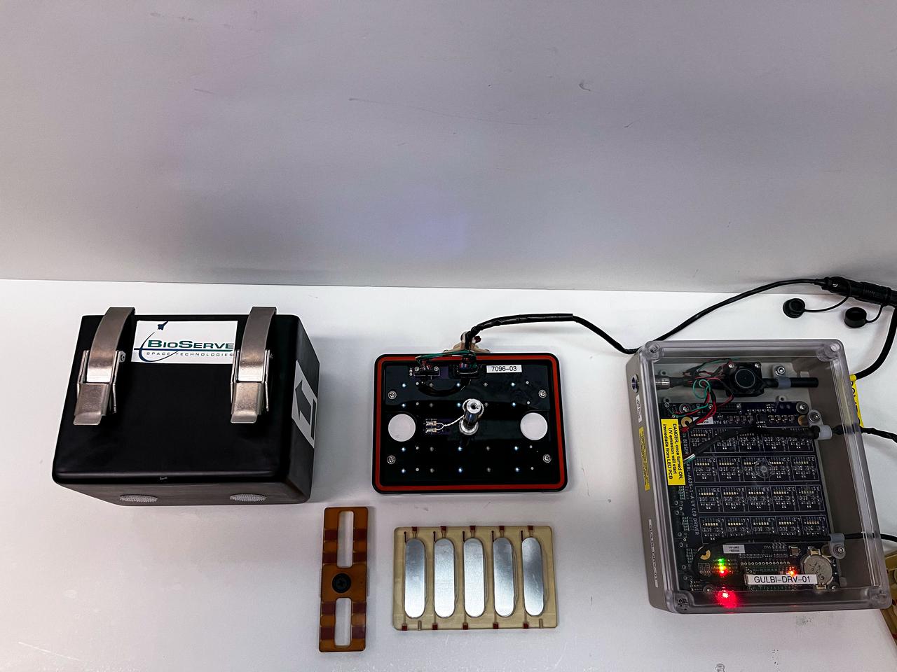 jsc2025e067421 (7/9/2025) --- Individual components of hardware for the GULBI investigation, which examines how microgravity affects the ability of a type of ultraviolet (UV) light to prevent formation of large communities of microbes called biofilms. Credit: Arizona State University