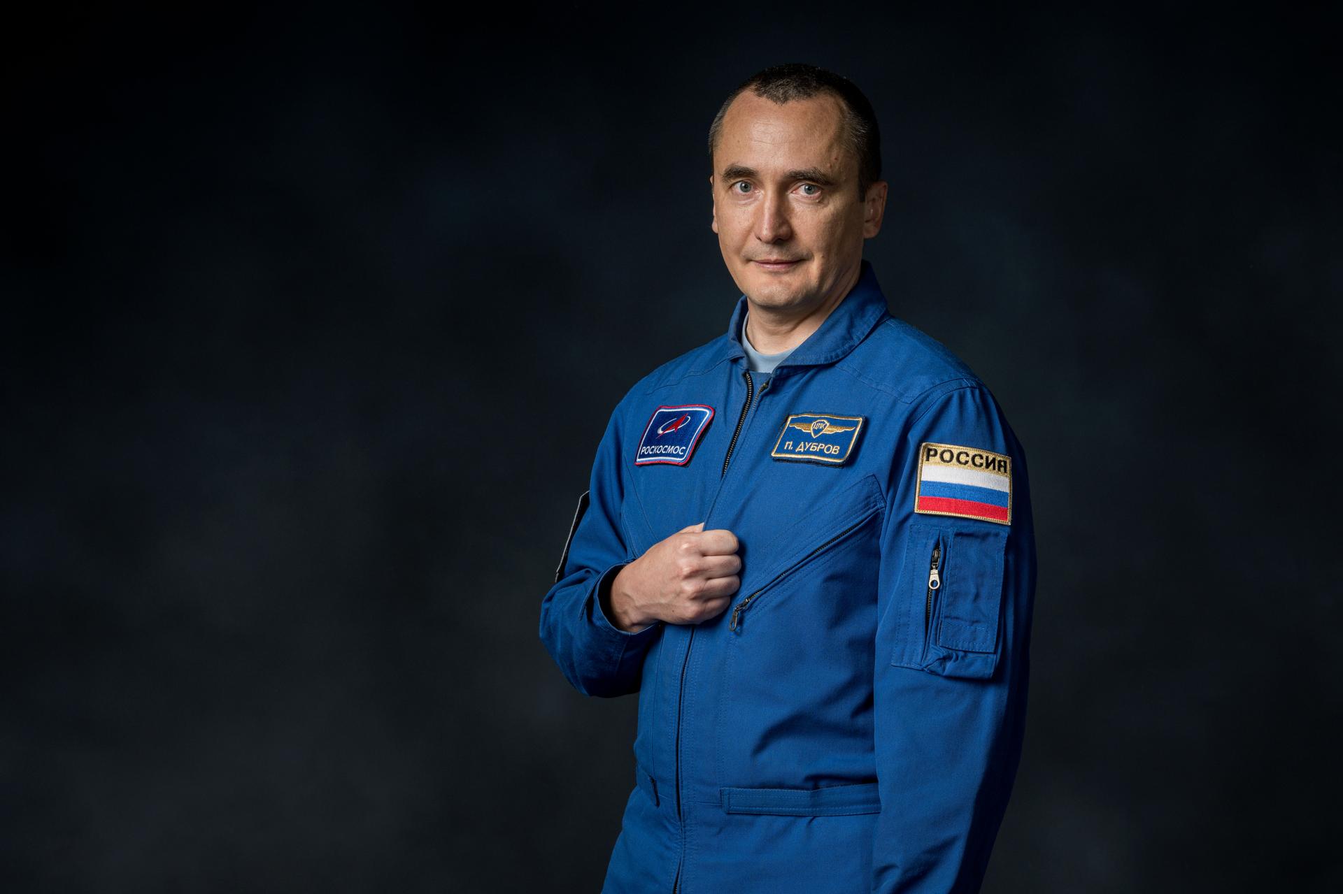 Roscosmos cosmonaut and Expedition 75 flight engineer Pyotr Dubrov poses for a preflight portrait at NASA's Johnson Space Center in Houston, Texas.