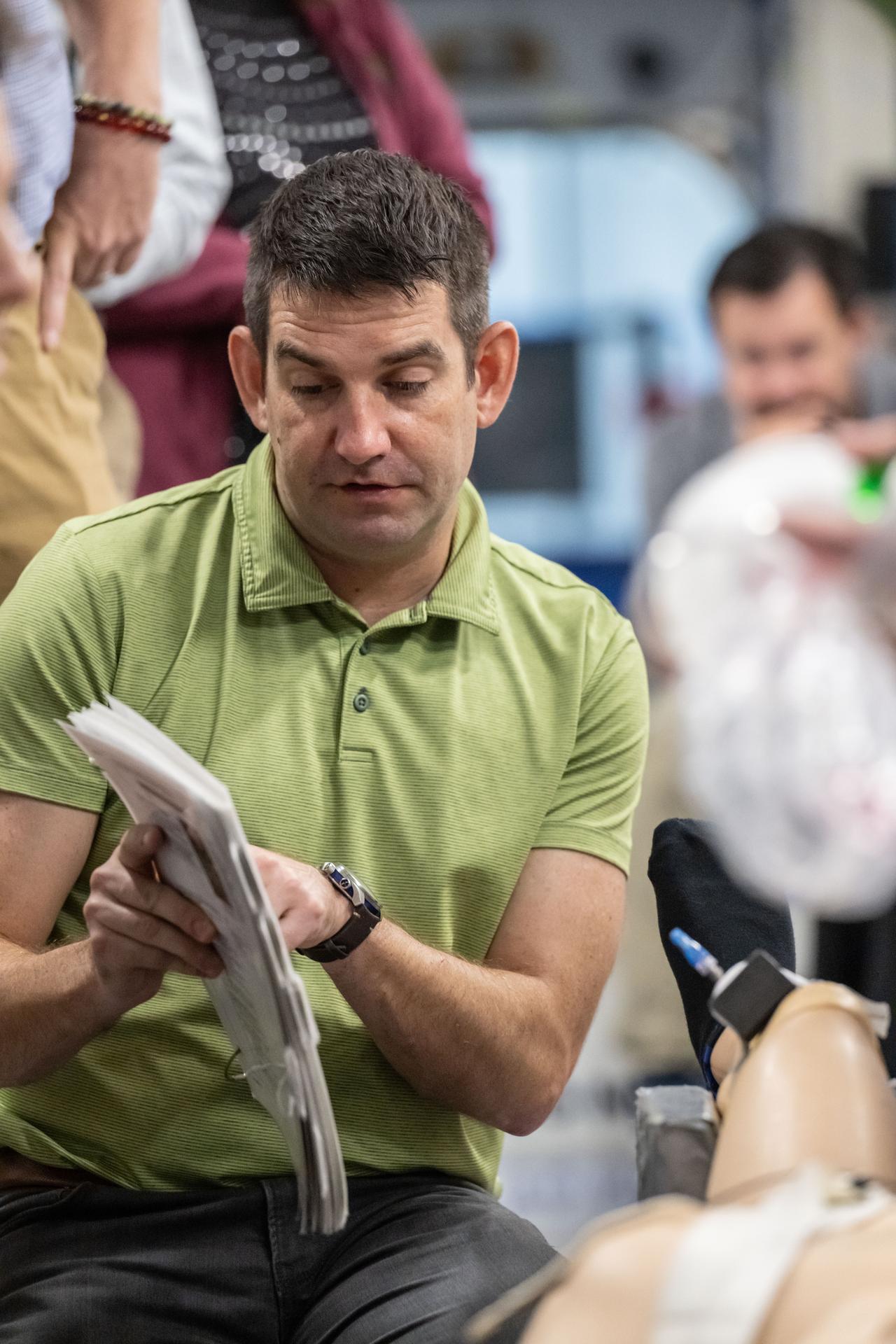 NASA astronaut Jack Hathaway reviews cardiopulmonary resuscitation (CPR) techniques during a medical emergency simulation as part of his training for NASA's SpaceX Crew-12 mission to the International Space Station. Surrounding Hathaway are various training support personnel at NASA's Johnson Space Center in Houston, Texas.