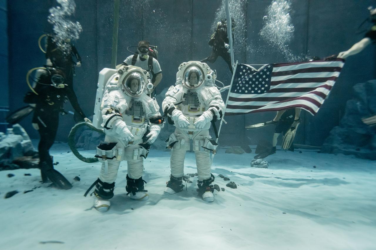 NASA astronauts Loral O’Hara (left) and Stan Love (right) pose for a photo during the first dual spacesuit run at NASA’s Neutral Buoyancy Laboratory while wearing Axiom Space’s lunar spacesuits. NASA and Axiom Space teams held the first dual spacesuit run at the Neutral Buoyancy Laboratory in Houston on September 24, 2025 with NASA Astronauts Stan Love and Loral O’Hara wearing Axiom Space’s lunar spacesuit, called the Axiom Extravehicular Mobility Unit (AxEMU). This was the final integration test in the pool, proving both the spacesuit and facility are prepped and ready for Artemis training.