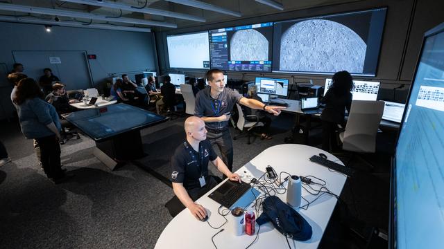 jsc2025e087237 --- Artemis lunar science team members Andrew Needham, sitting...