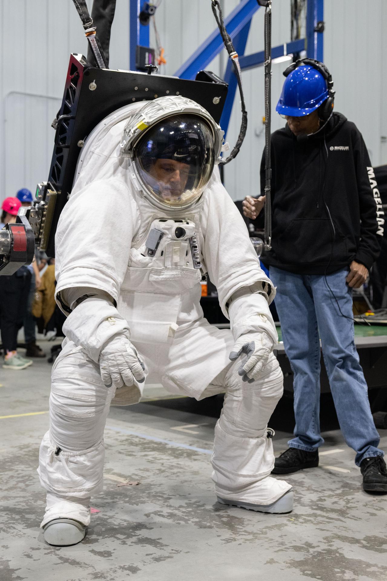 Artemis II astronaut Reid Wiseman assesses lower-body mobility in the xEMU spacesuit during the Artemis Spaceflight Standard Measures Test at NASA’s Johnson Space Center on Dec. 8, 2025. (NASA/Josh Valcarcel)