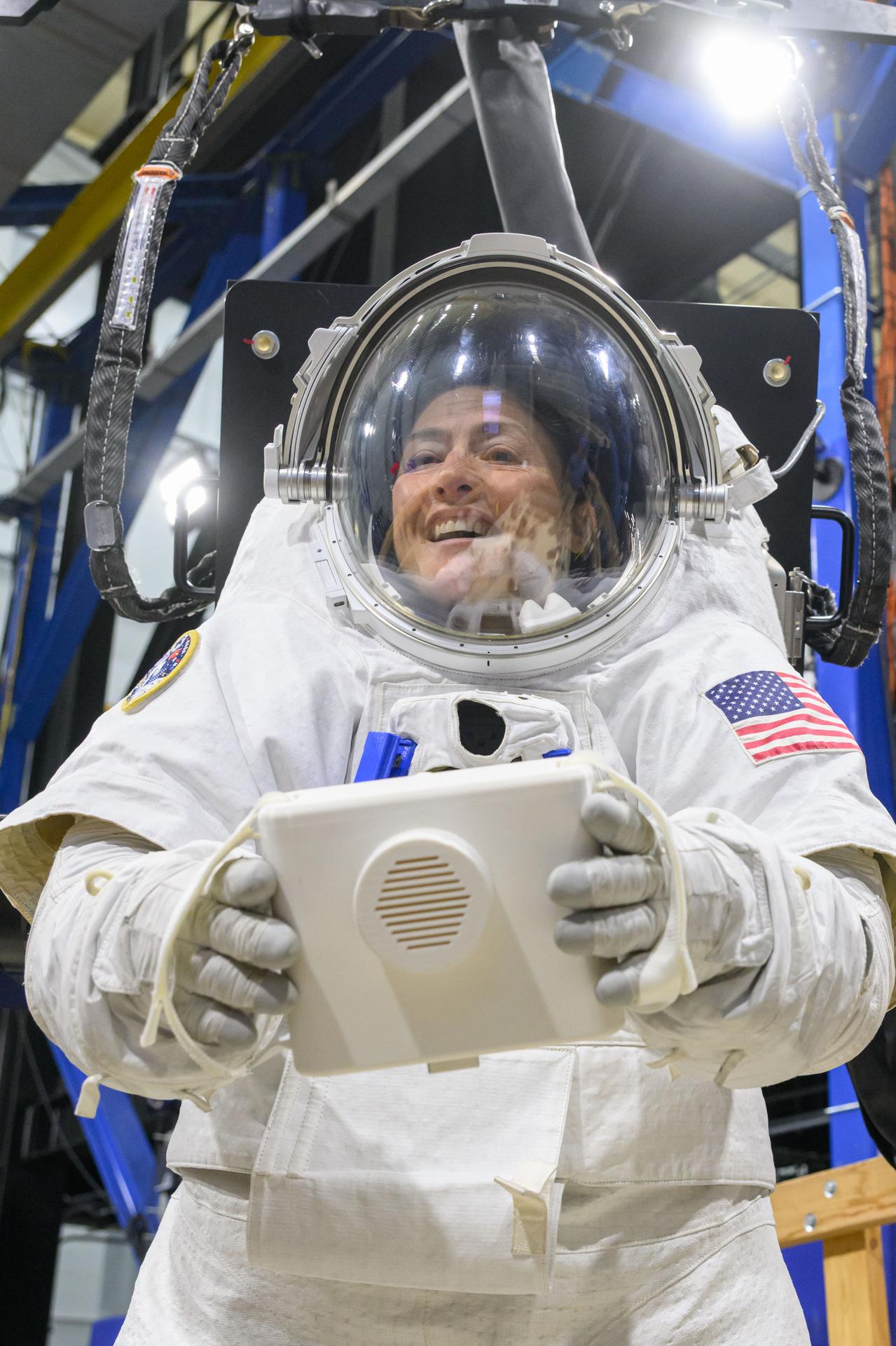 Artemis II astronaut Christina Koch uses a mockup camera as part of performing the Egress Fitness Task series inside the ARGOS test area at NASA’s Johnson Space Center on Dec. 12, 2025. (NASA/Helen Arase Vargas)