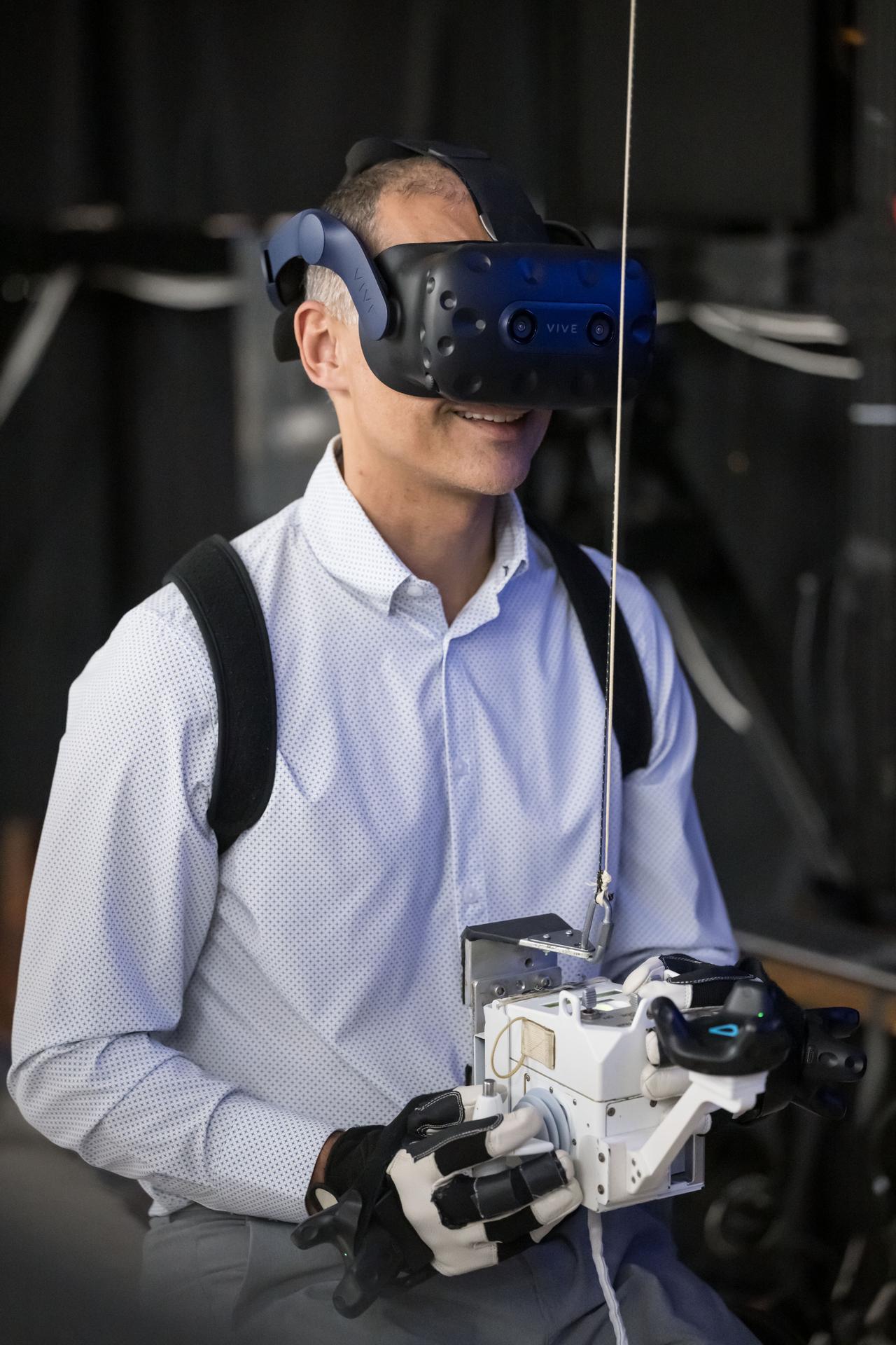 NASA astronaut and Expedition 75 flight engineer Anil Menon participates in a spacewalk training session while wearing virtual reality goggles at Johnson Space Center in Houston, Texas, ahead of his upcoming mission to the International Space Station.