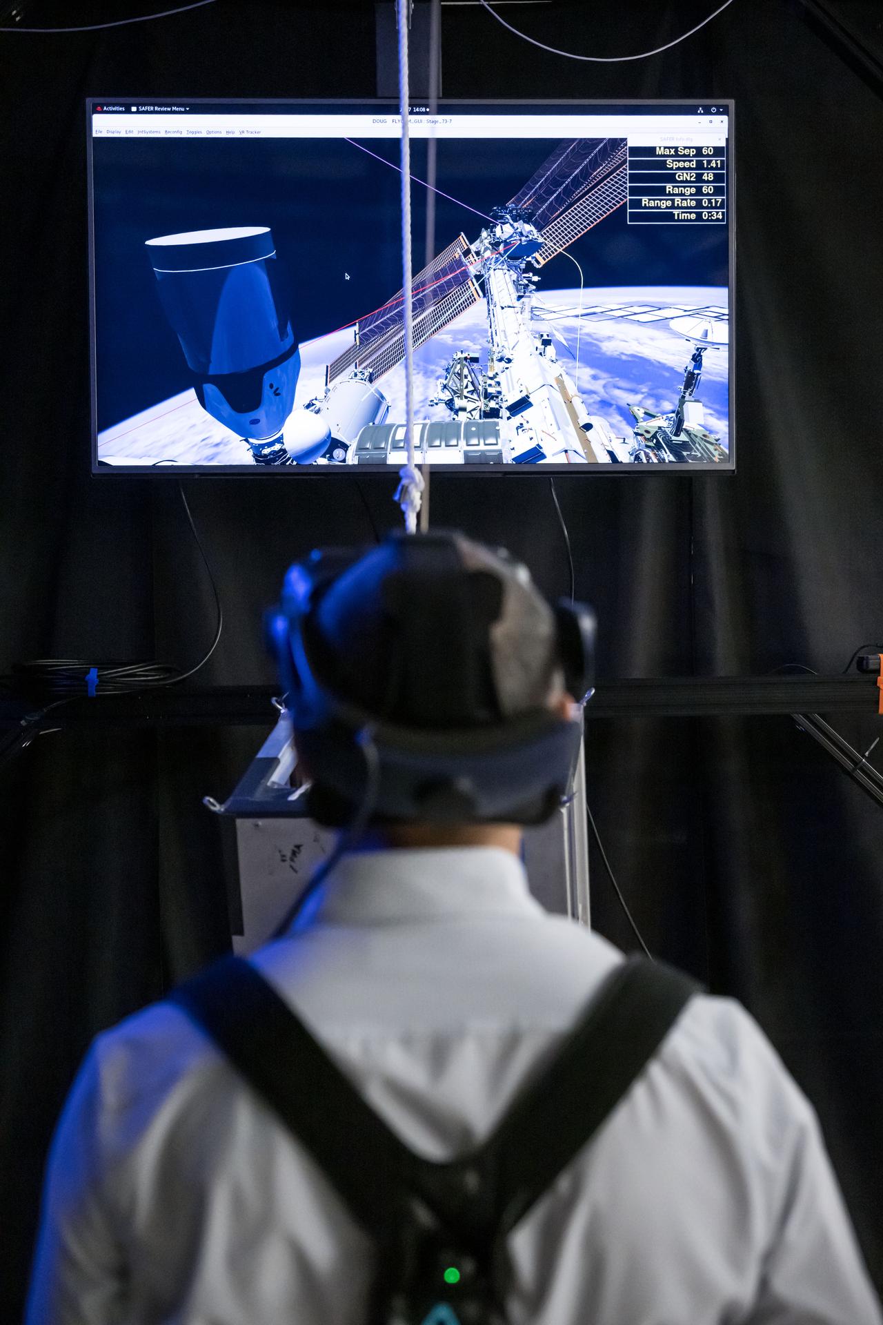 NASA astronaut and Expedition 75 flight engineer Anil Menon participates in a spacewalk training session while wearing virtual reality goggles at Johnson Space Center in Houston, Texas, ahead of his upcoming mission to the International Space Station.