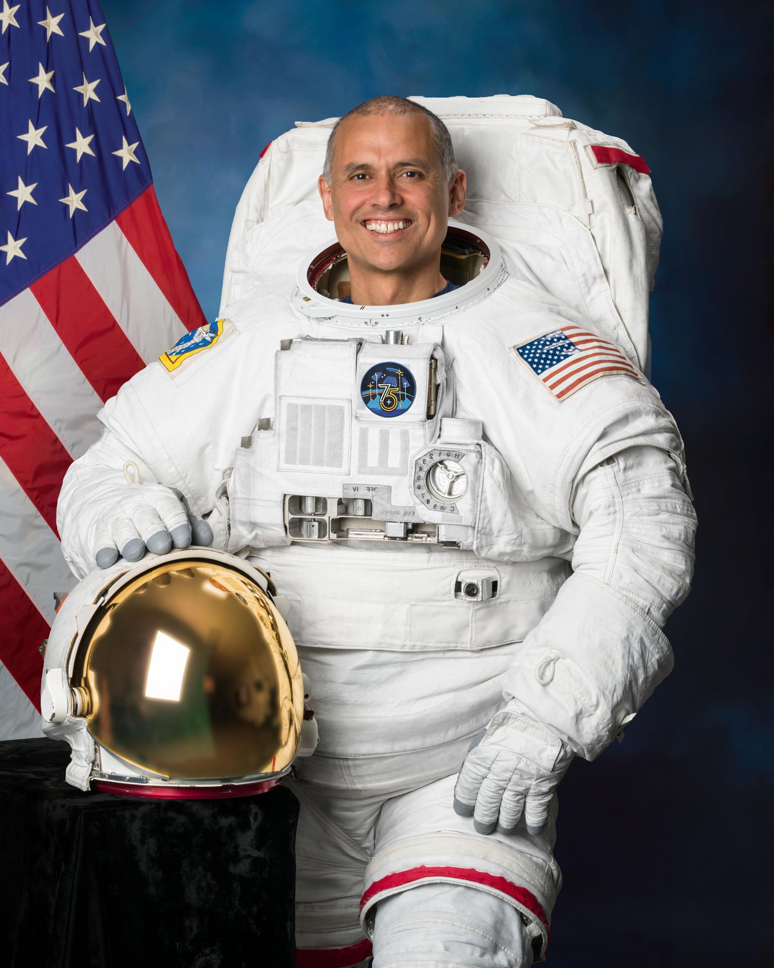 NASA astronaut and Expedition 75 flight engineer Anil Menon poses in a spacesuit for his official portrait at NASA's Johnson Space Center in Houston, Texas.