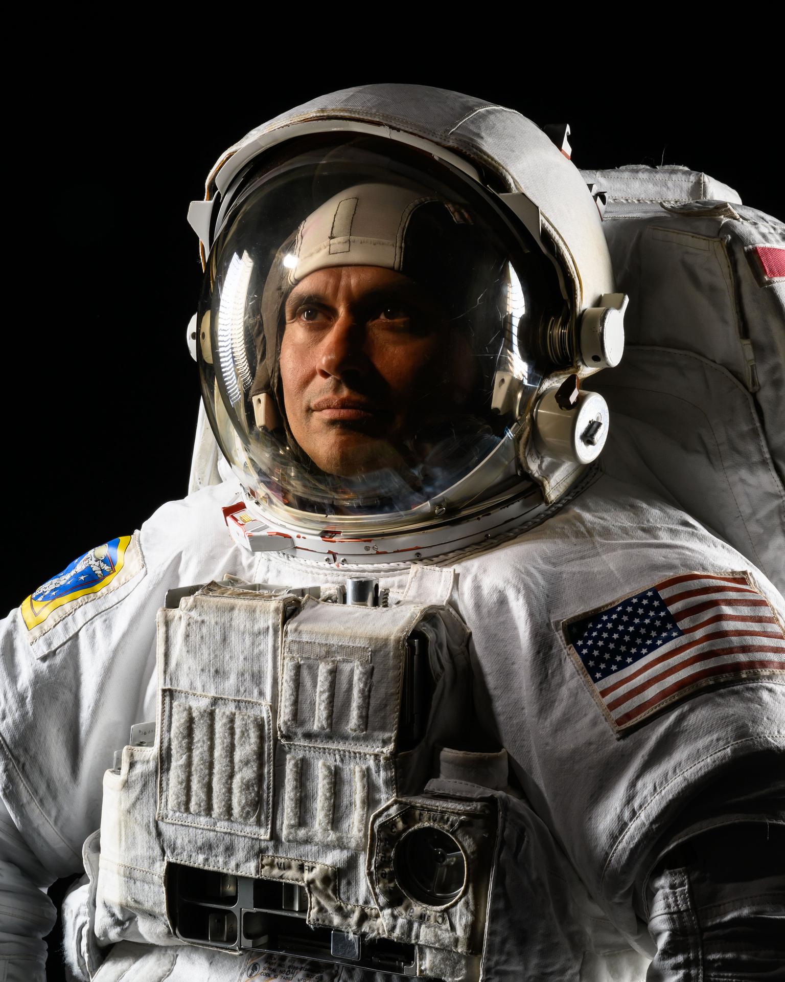 NASA astronaut and Expedition 75 flight engineer Anil Menon poses in a spacesuit for a portrait at NASA's Johnson Space Center in Houston, Texas.