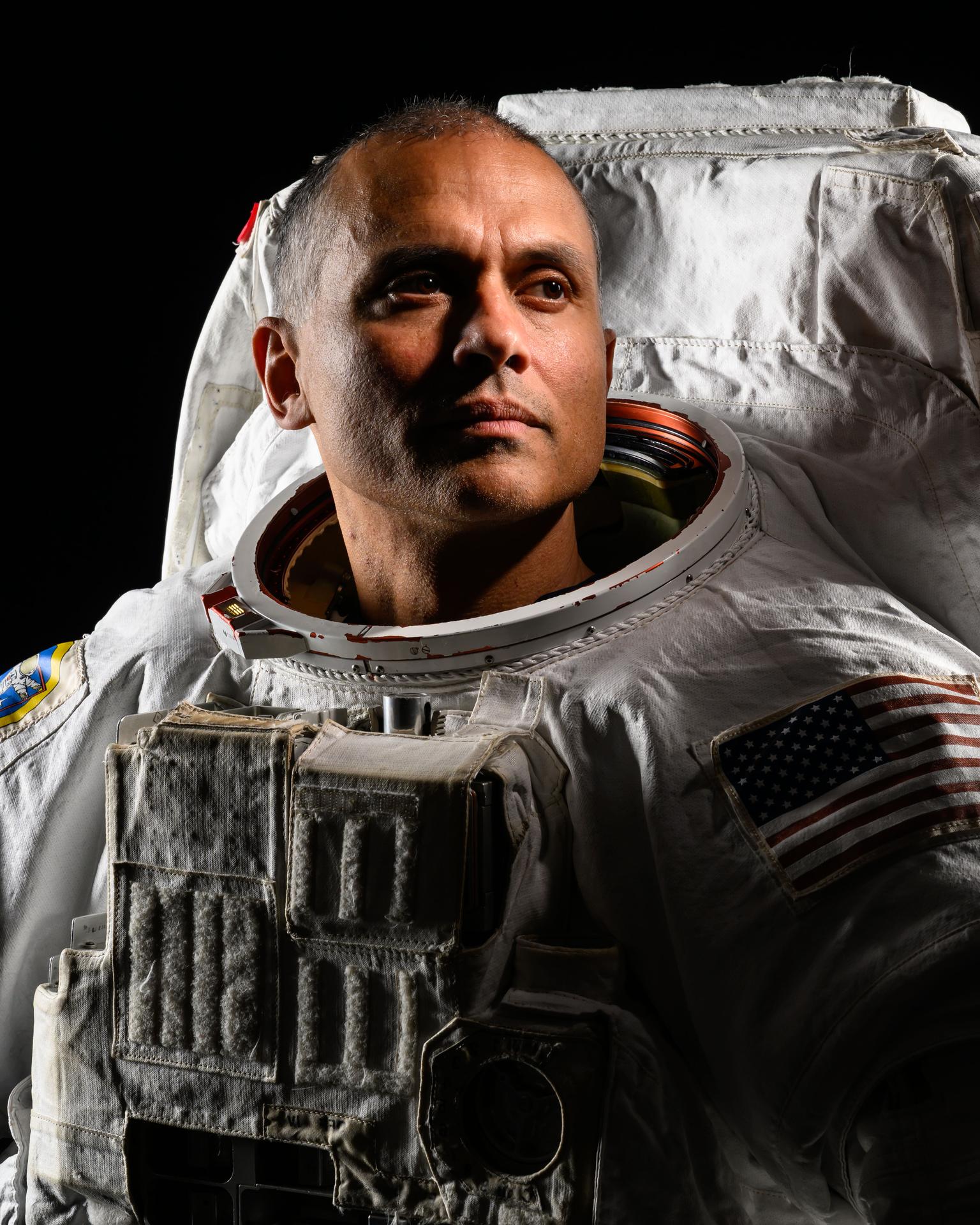 NASA astronaut and Expedition 75 flight engineer Anil Menon poses in a spacesuit for a portrait at NASA's Johnson Space Center in Houston, Texas.