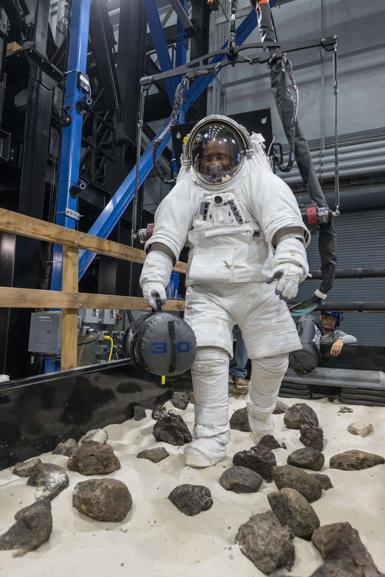 Artemis II astronaut Victor Glover performs a simulated surface logistics task while attached to the ARGOS system during the Egress Fitness Task Battery at NASA’s Johnson Space Center on Jan. 13, 2026. (NASA/Robert Markowitz)