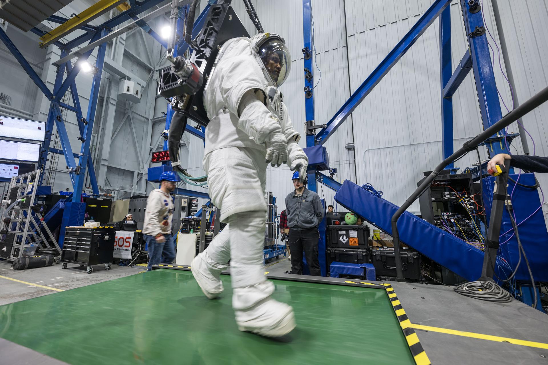 Artemis II astronaut Victor Glover walks across a mobility surface during an Egress Fitness Task evaluation during the Artemis Spaceflight Standard Measures Test at NASA’s Johnson Space Center on Jan. 13, 2026. (NASA/Robert Markowitz)