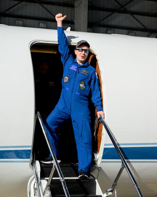NASA image: Roscosmos cosmonaut Oleg Platonov waves to officials at Ellington Field in Houston, Texas