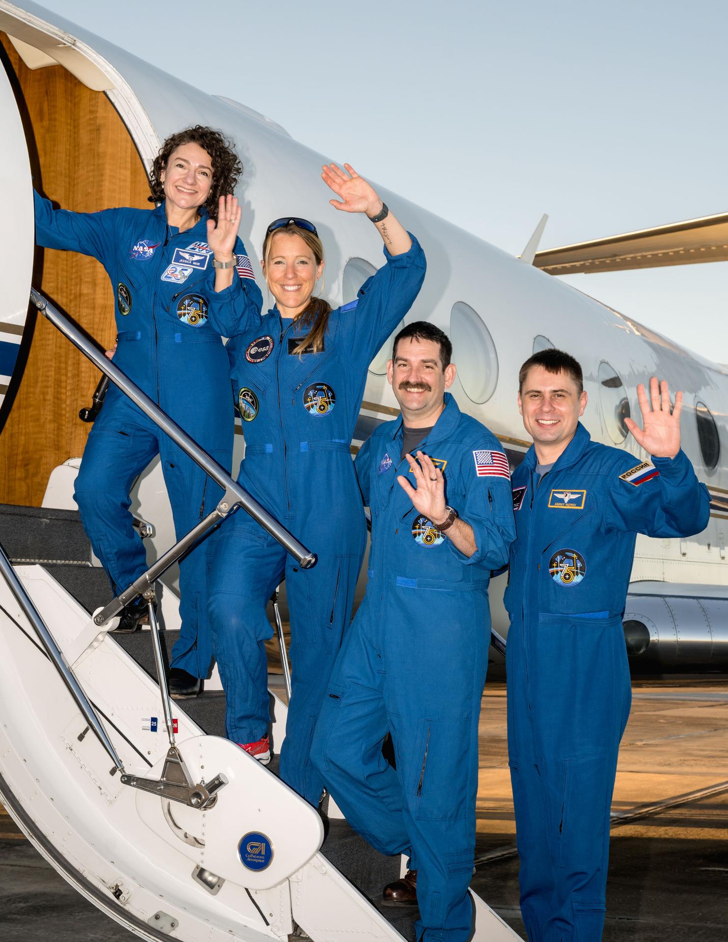 Four crew members representing NASA's SpaceX Crew-12 mission to the International Space Station wave to the camera prior to departing from Ellington Field in Houston, Texas, to Kennedy Space Center in Florida. From left are, Commander Jessica Meir of NASA, Mission Specialist Sophie Adenot of ESA (Euroean Space Agency), Pilot Jack Hathaway of NASA, and Mission Specialist Andrey Fedyaev of Roscosmos.