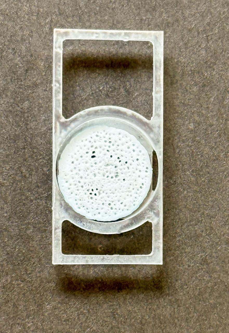 jsc2026e017240 (March 27, 2026) --- Preflight image of Aa b.Bone biomaterial scaffold is positioned within a custom 3D-printed sample holder, engineered to securely house the scaffold inside the SPHINX bioreactor as part of the Green Bone investigation. This research studies how human mesenchymal stem cells (hMSCs) grow on a biomimetic bone scaffold, b Bone, made from rattan wood in microgravity. .Credit:. GreenBone Ortho.