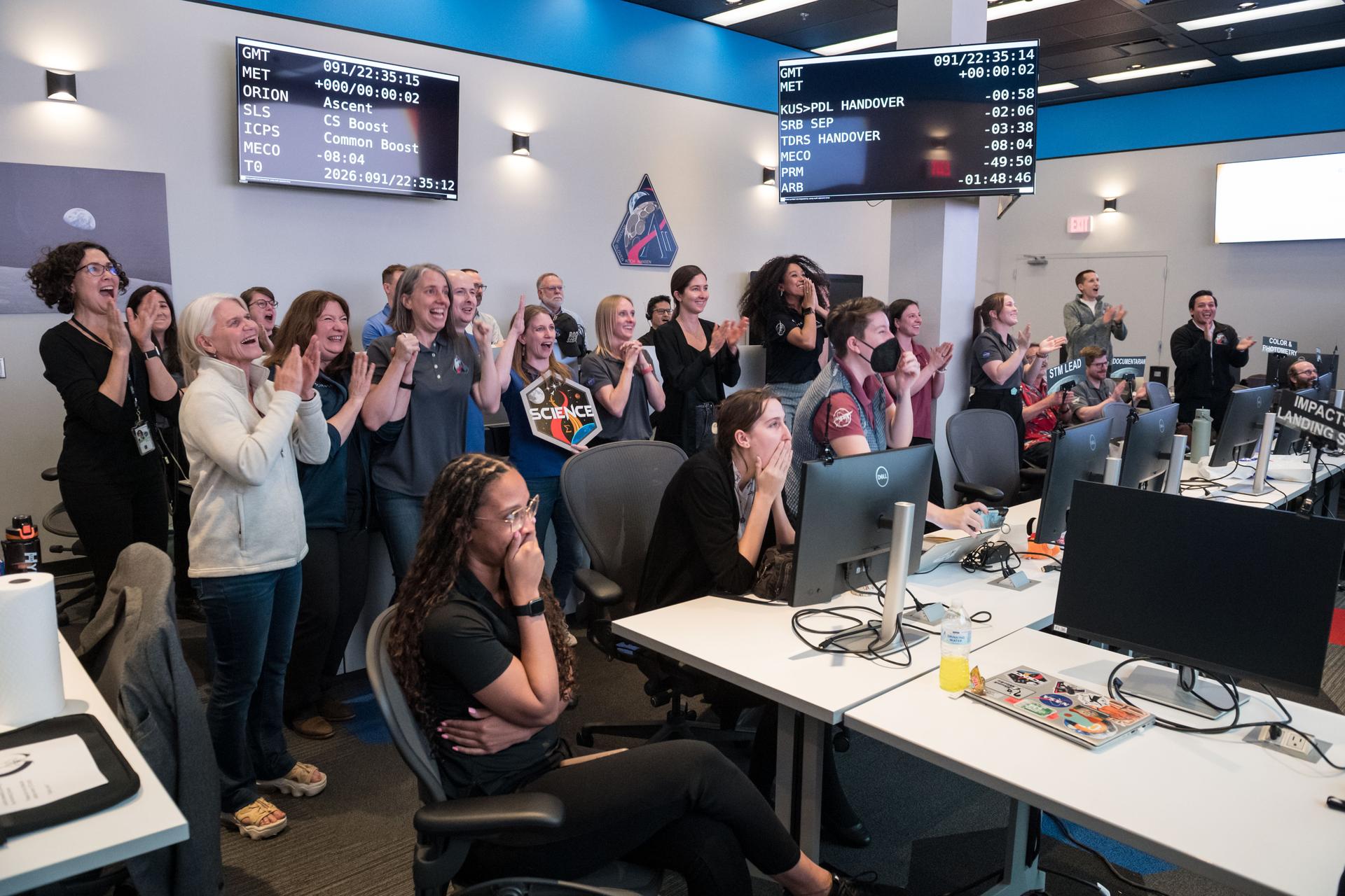 Members of the Artemis lunar science team celebrate the Artemis II launch as they watch from the Science Evaluation Room (SER) in Mission Control at NASA's Johnson Space Center in Houston. The SER supports lunar science and planetary observations for the Artemis science officer in the mission’s main flight control room. Built specifically for Artemis missions with these science priorities in mind, the SER is equipped to support rapid data interpretation, collaborative analysis, real-time decision making, and seamless coordination between the science and operations teams. Credits: NASA/Mark Sowa.