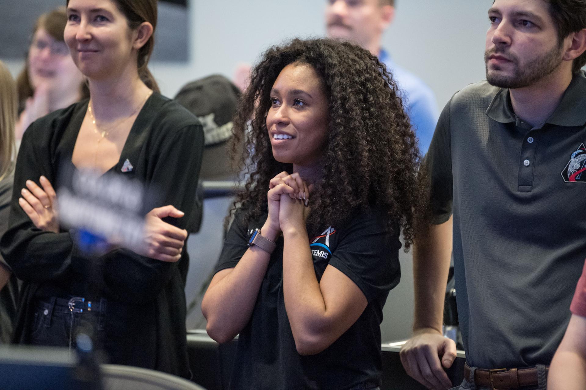 Members of the Artemis lunar science team, from left, Ariel Deutsch, Amber Turner, and Wilfredo Garcia-Lopez, watch the Artemis II launch from the Science Evaluation Room (SER) in Mission Control at Johnson Space Center in Houston. The SER supports lunar science and planetary observations for the Artemis science officer in the mission’s main flight control room. Built specifically for Artemis missions with these science priorities in mind, the SER is equipped to support rapid data interpretation, collaborative analysis, real-time decision making, and seamless coordination between the science and operations teams. Credits: NASA/Mark Sowa.