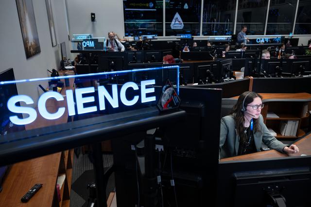Artemis II science officer Kelsey Young monitors science operations at the ne...